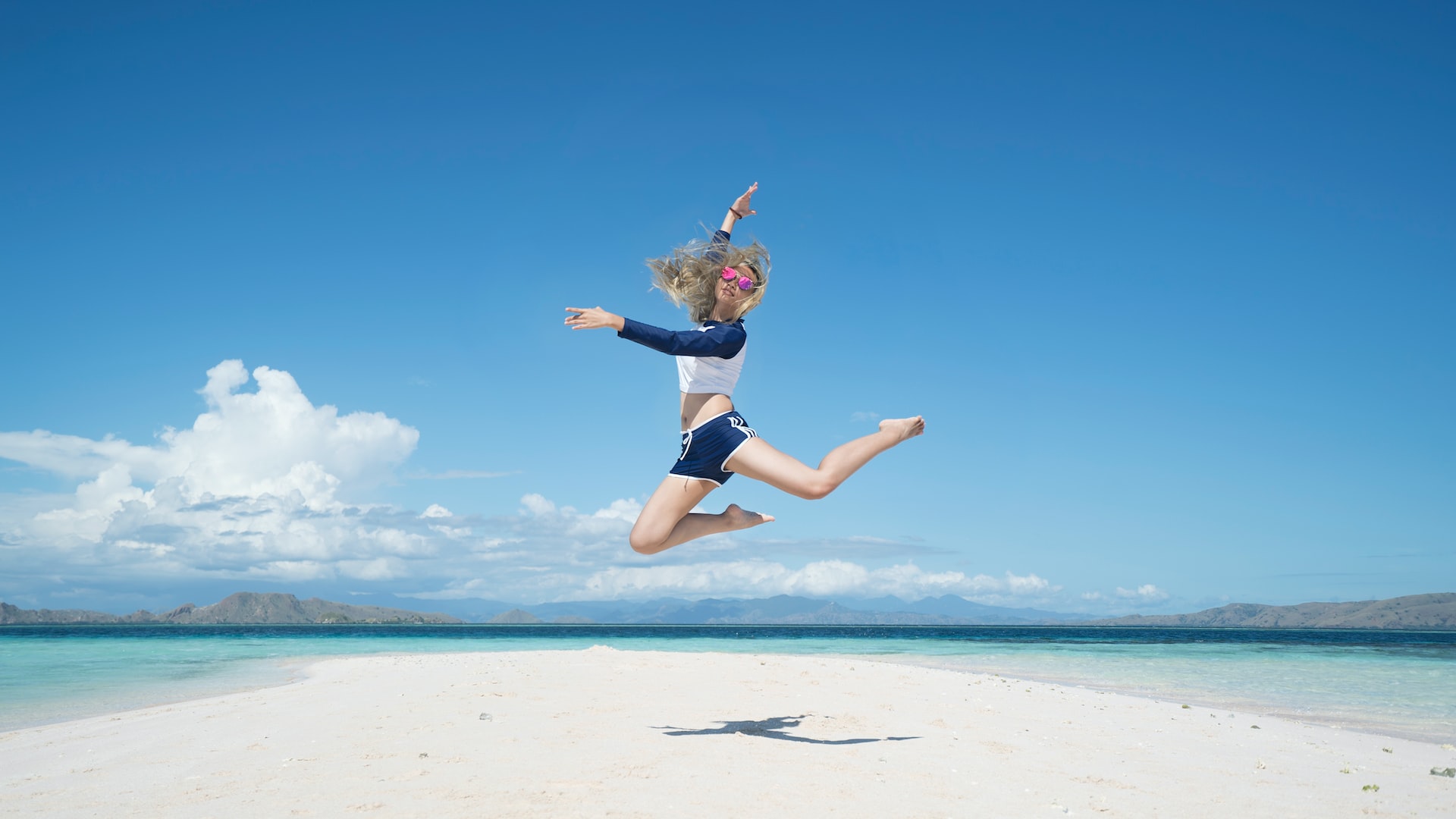 woman jumping with raising her right hand